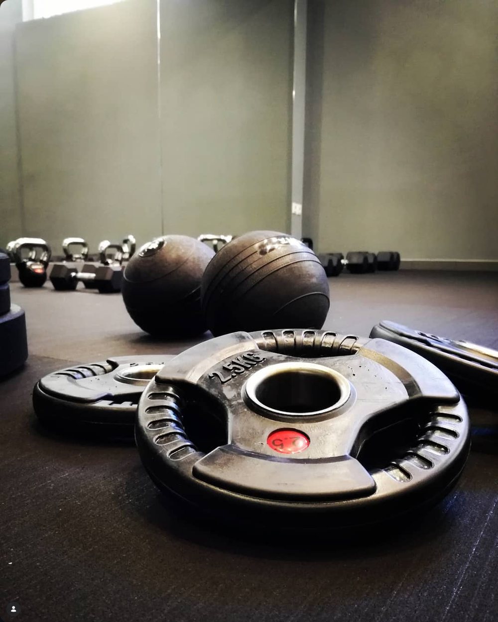 Olympic weight plates and slam balls at the Hack Fit studio